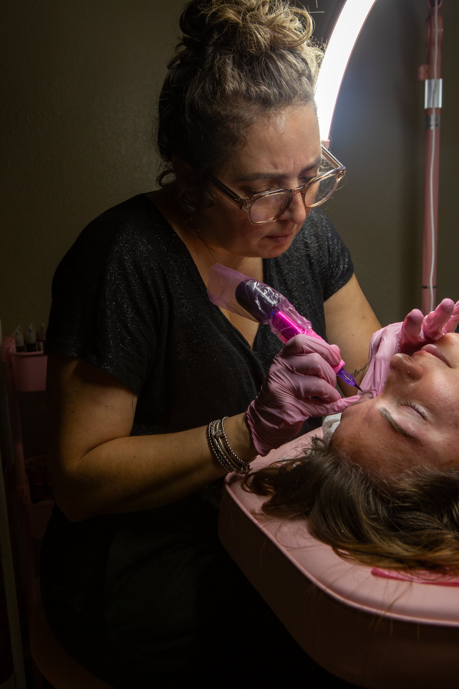 Dominique performing permanent makeup